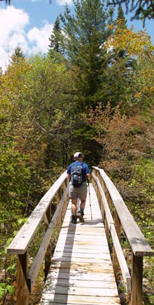 Cheryl crossing the bridge over the North Fork (photo by Webmaster)