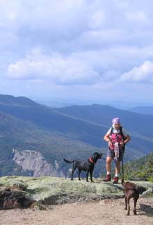 Deb and her dogs with a mountainous backdrop (photo by Mark Malnati)